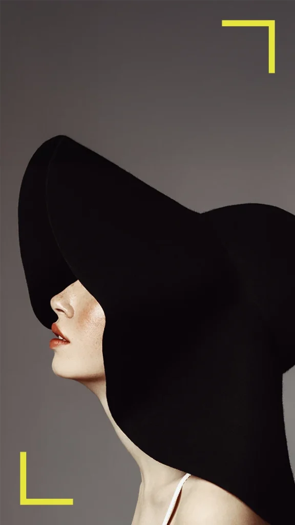 Woman's side profile in oversized black hat