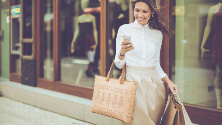 a woman walking the street with her purse