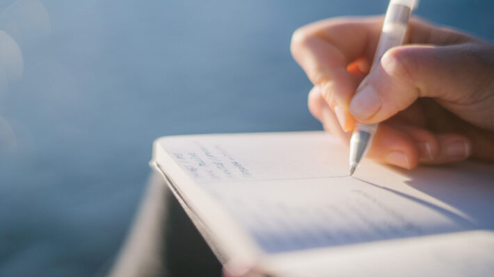 hand writing in a journal