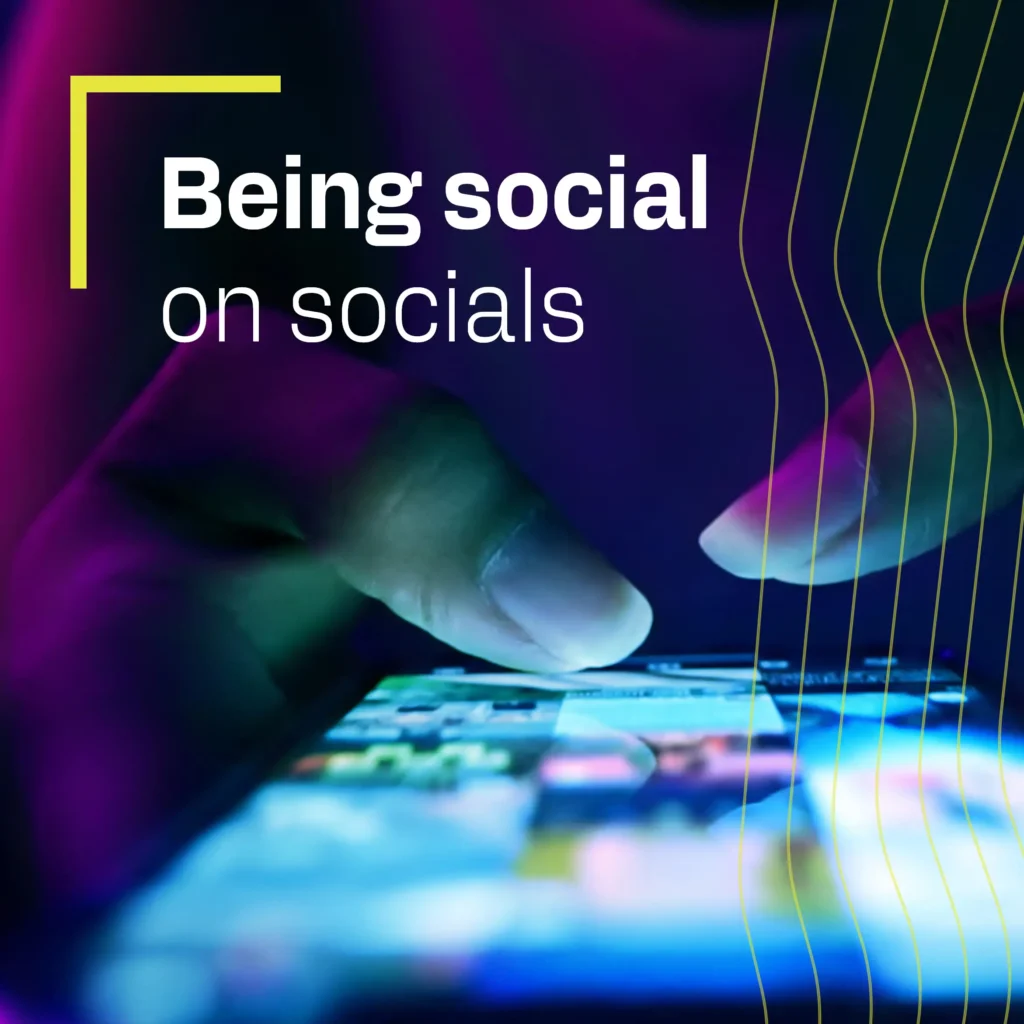 A person using a phone and the text "being social on socials"
