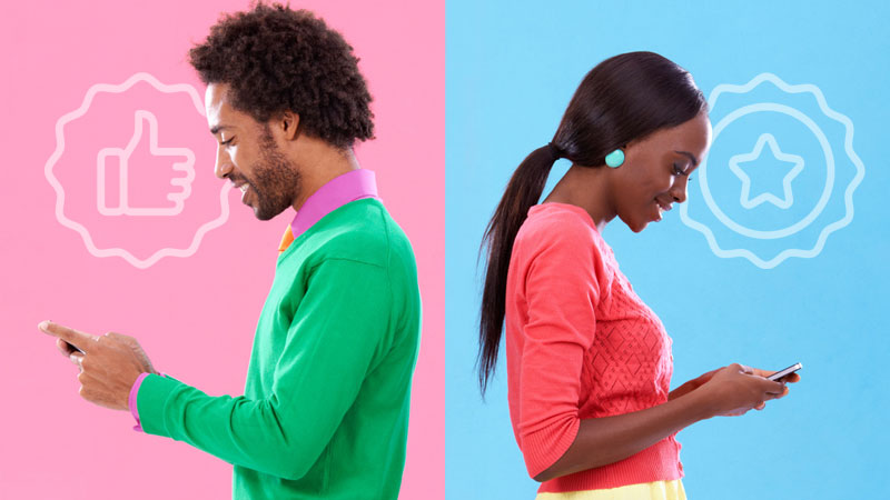 two people looking at their phones with their backs to each other.