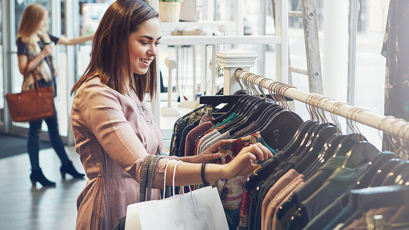 a shopper browsing clothes in a retail setting