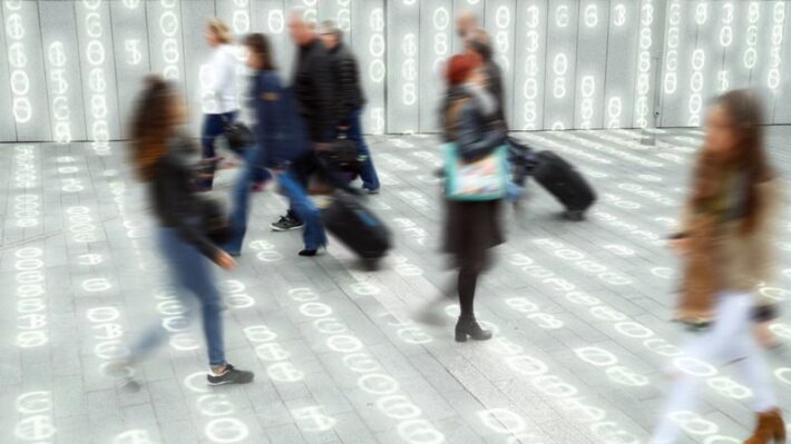 A crowd of people walking by, with code representing data all around them