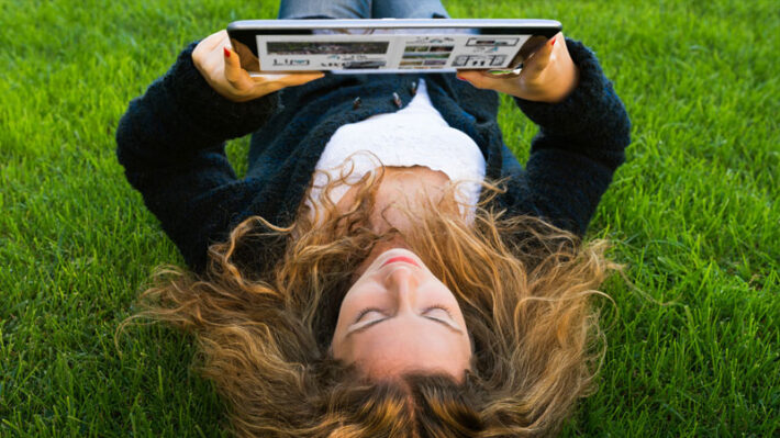 a woman using a tablet to consume content