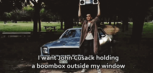 a gif of a man holding a boom box