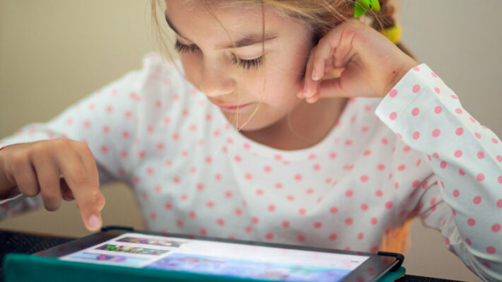 a child looking at a tablet