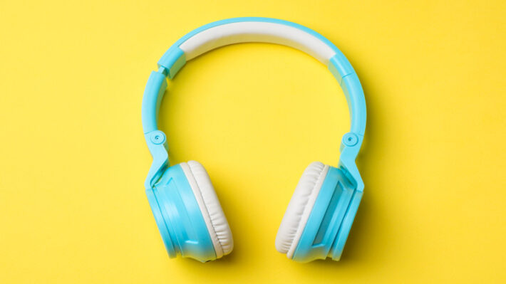 blue headphones on yellow background