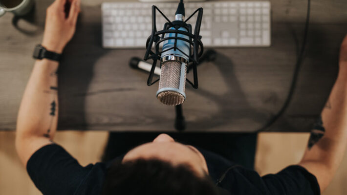 A podcasting setup with a microphone and keyboard.