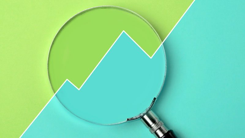 a magnifying glass over a performance report