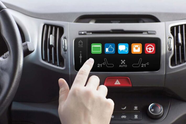 A finger choosing options on a car's infotainment system