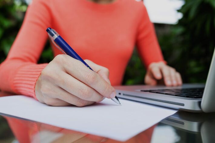 woman writing in a book