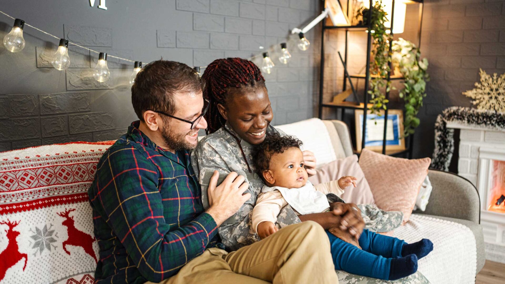 Multi-cultural family sitting together on couch in living room