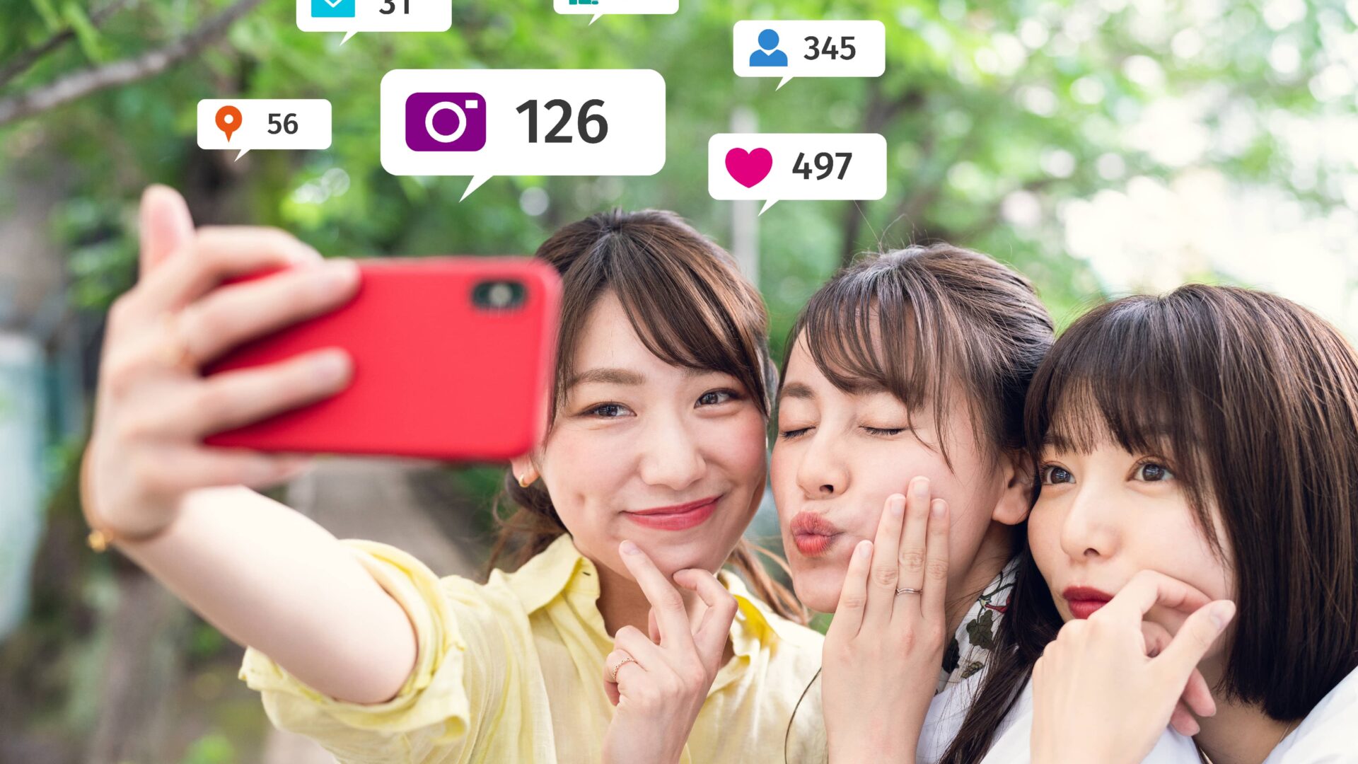 Three minority women taking a group selfie