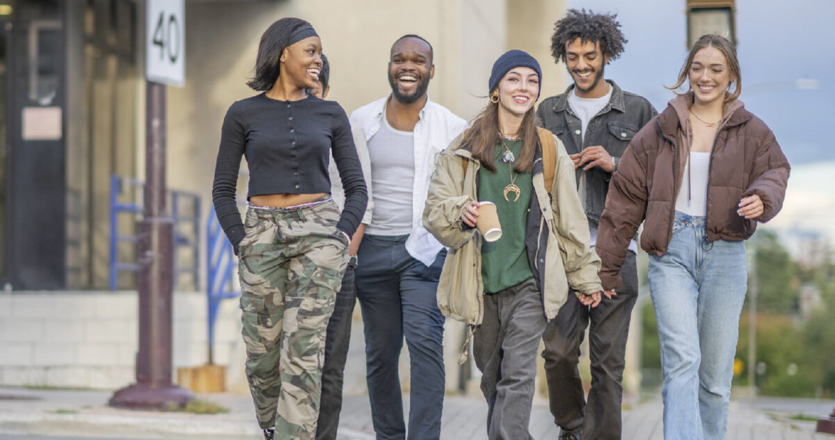 a diverse group of friends walking while wearing urban clothing 