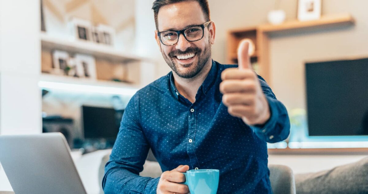 A content creator smiling and giving a thumbs up.