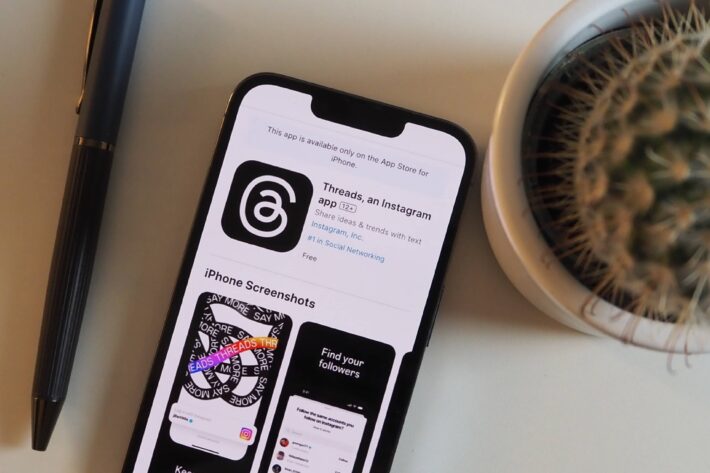 a phone in the App Store viewing the new Threads app