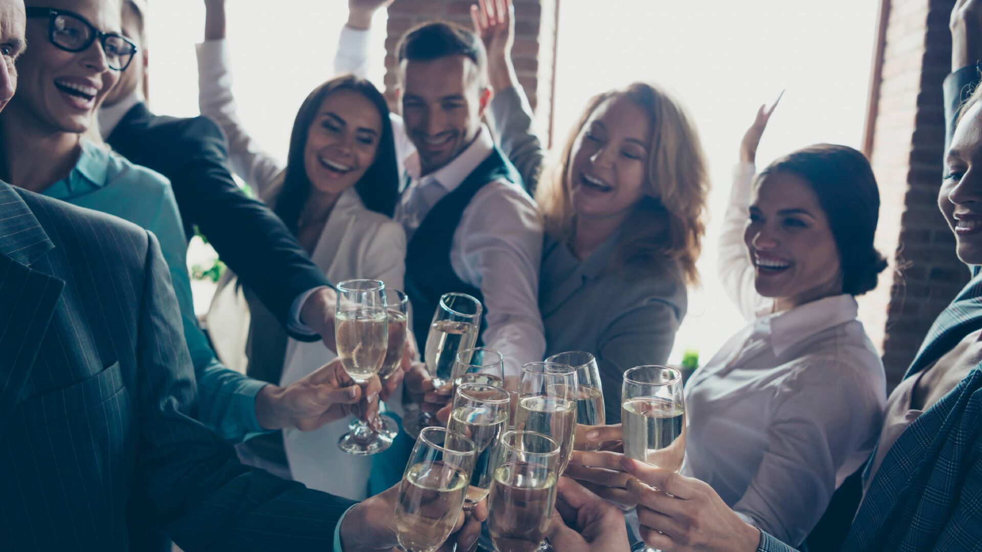 a staff of people cheering champagne glasses