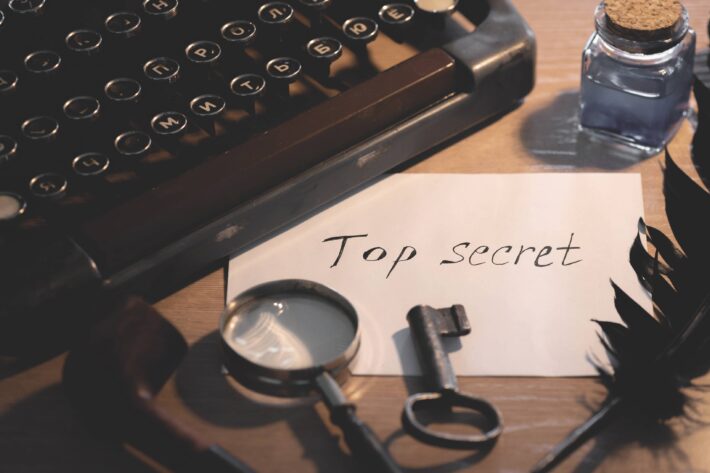 a piece of white paper on a desk that says "Top Secret"