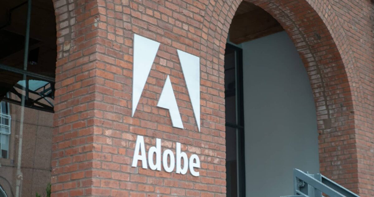 Exterior of a building, brick with Adobe's logo in minimalist white. 