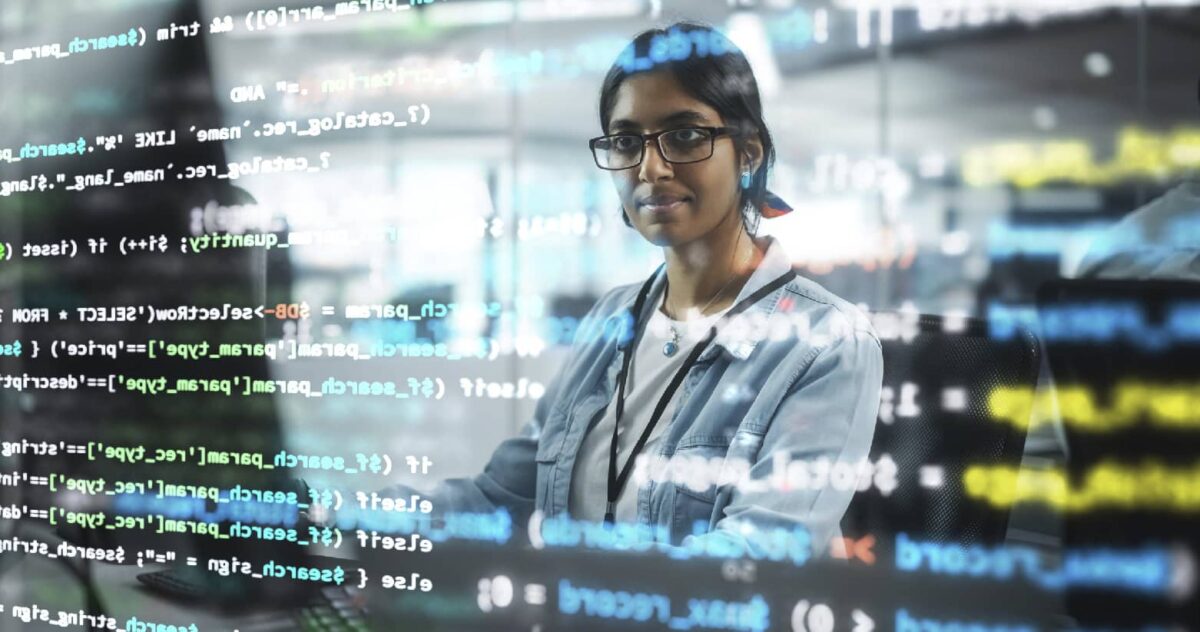 A woman reviewing code on a screen