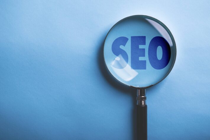 a magnifying glass hovering over the word "SEO"