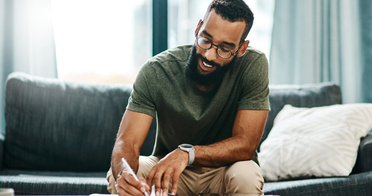 A man writing something with a stylus.