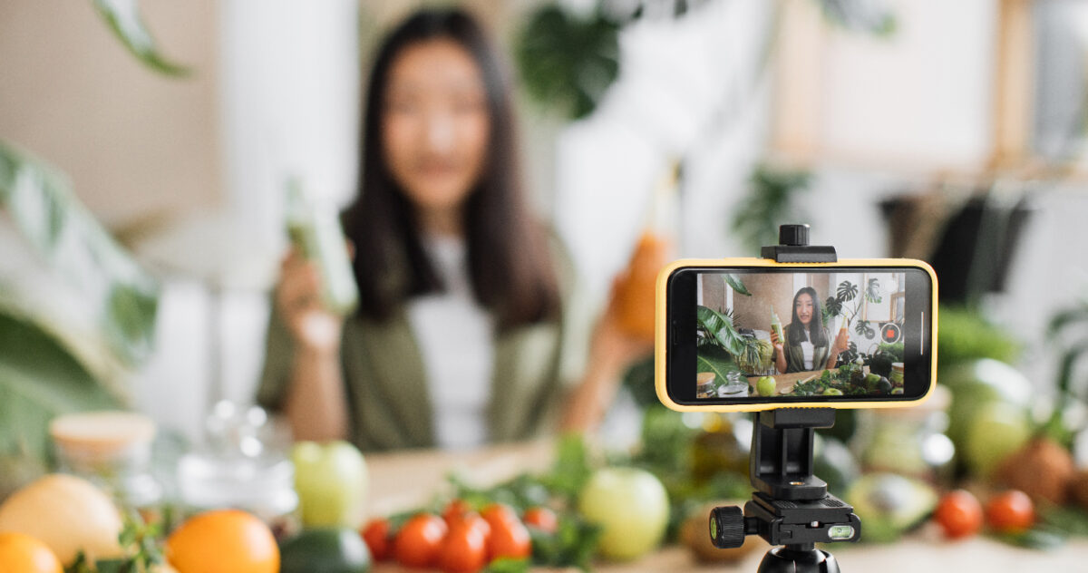 An influencer creating marketing content on a mobile phone.