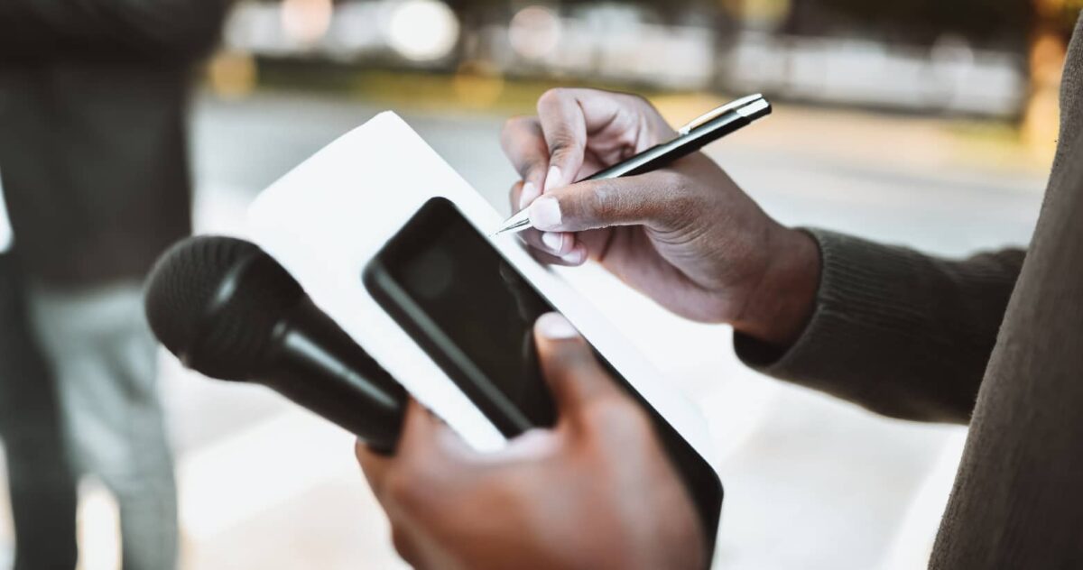 An audio artist writing notes in a notebook