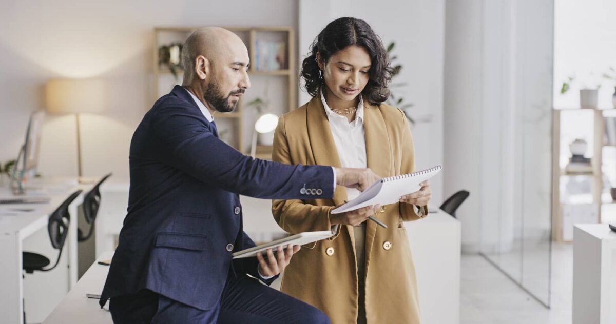 Two professionals exchanging feedback in an office setting