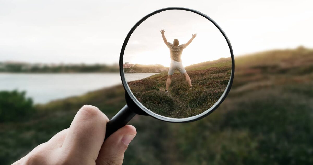 An image of a magnifying glass on a person, representing audience alignment in brand loyalty marketing