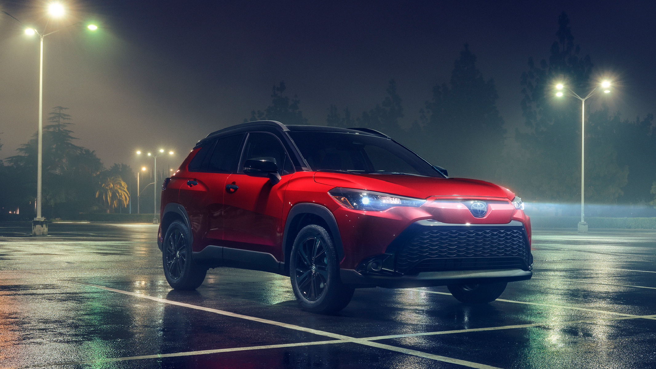 A red Toyota SUV in a rainy parking lot