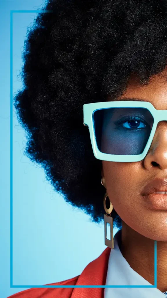 A person wearing bold blue glasses