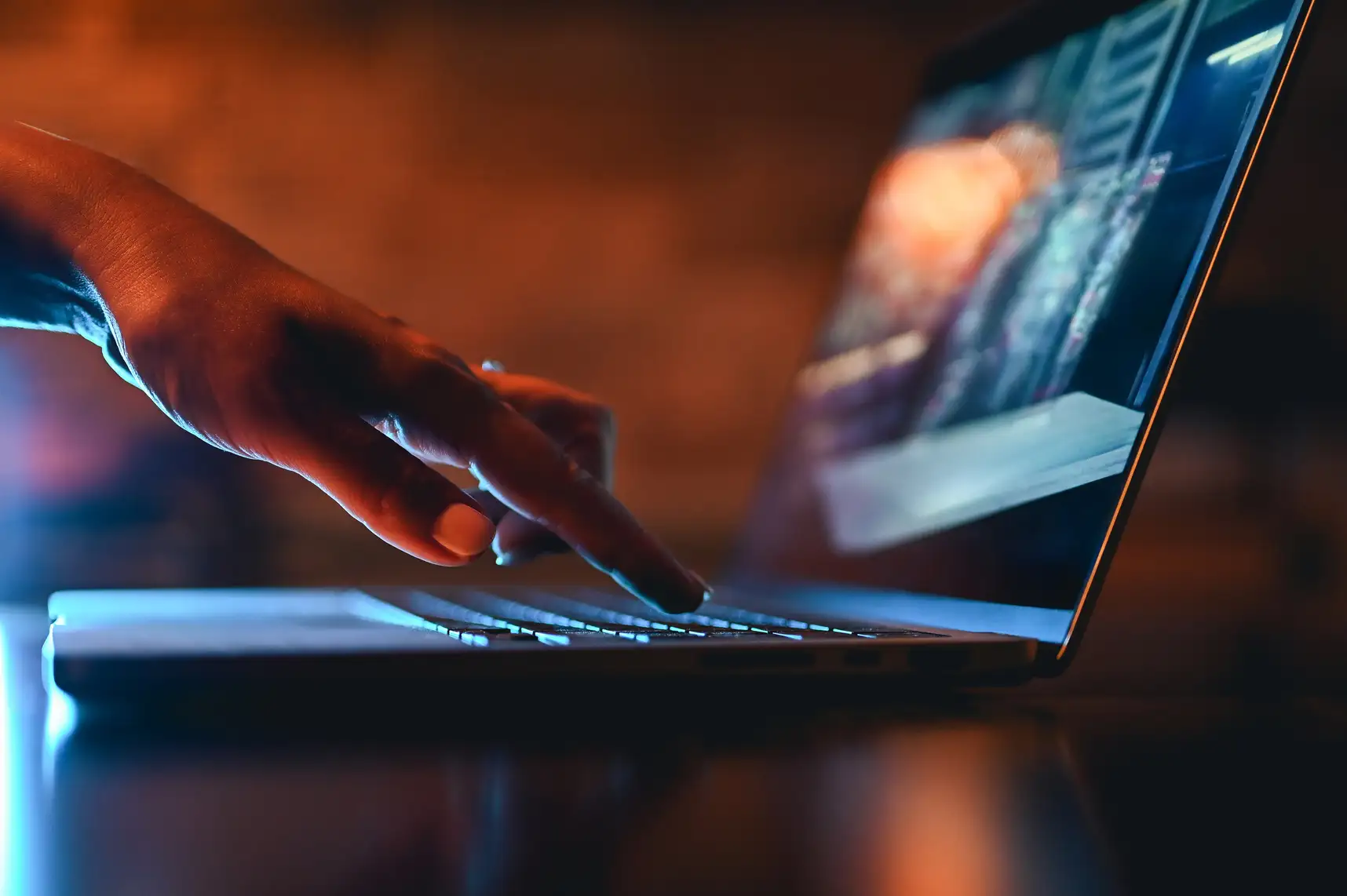Photo of hand typing on laptop computer.